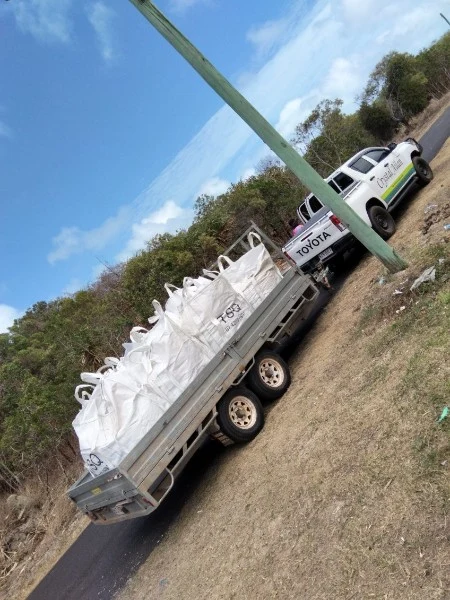 A trailer carrying collection bags behind the Crystal Ailan ute.