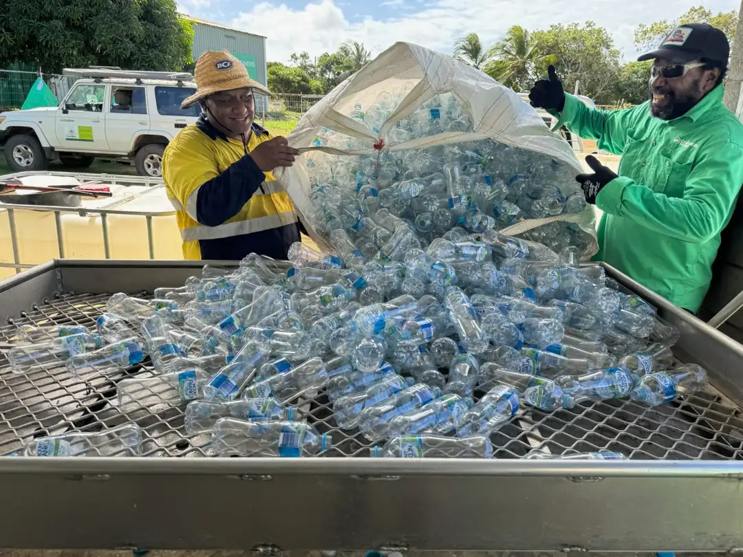 Recovered drink containers being tipped into a sorting cage at the Badu depot.